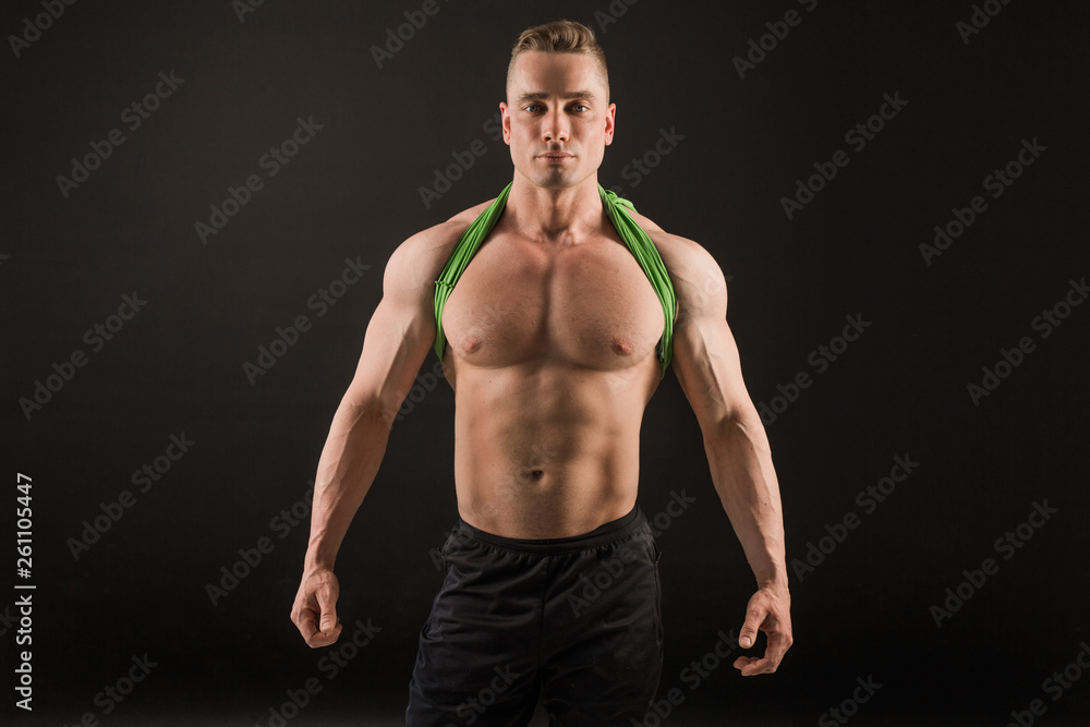 Fototapeta premium handsome man with muscles on a black background