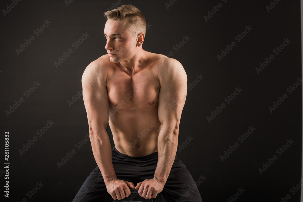 handsome man with muscles on a black background