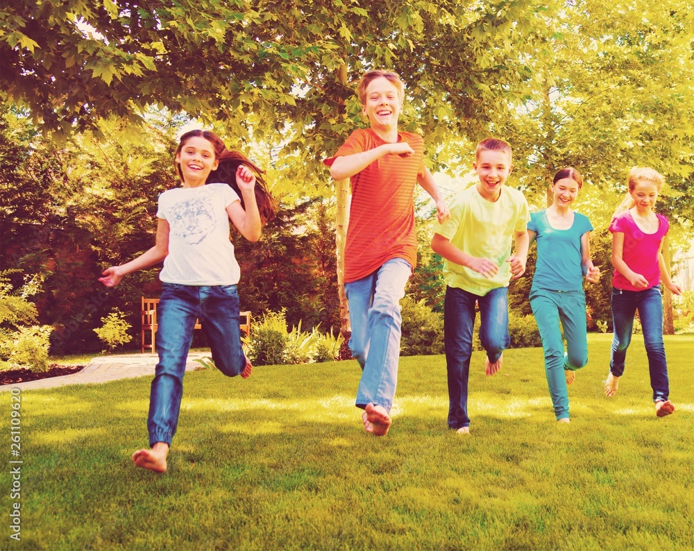 Fototapeta premium Happy children running and playing in garden on sunny day