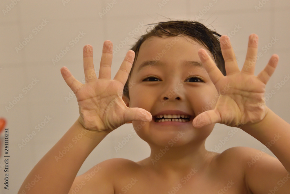 Cute boy smiling after shower showing hands with wrinkles Cute boy smiling after shower showing hands with wrinkles