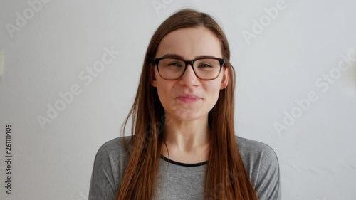 young girl laughs standing isolated over white background