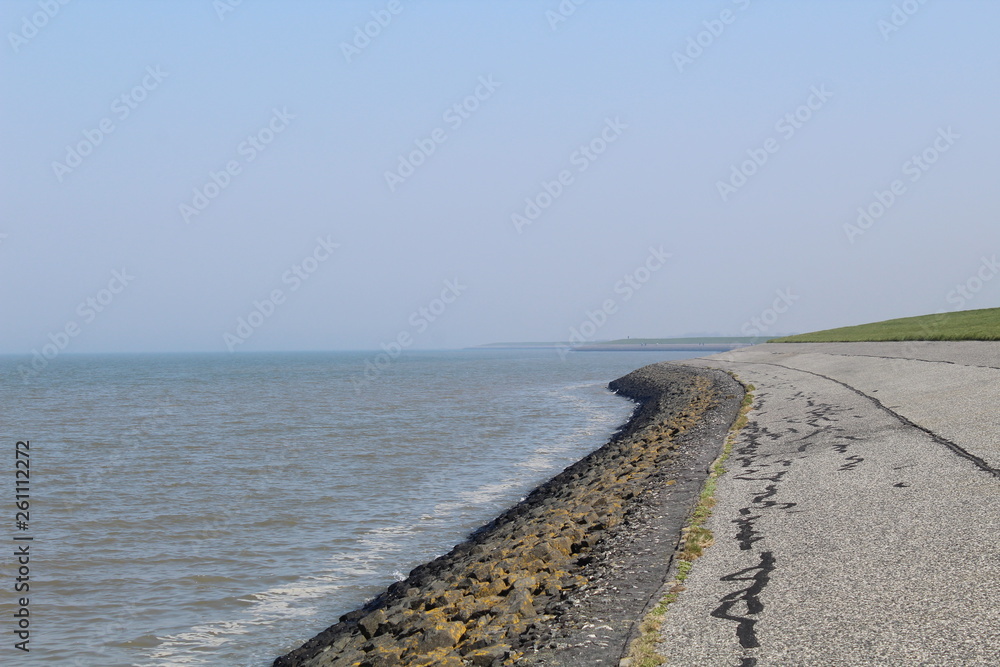 Ostbense, Germany: the dike along the coast on the Wadden Sea Ostbense, Germany: the dike along the coast on the Wadden Sea