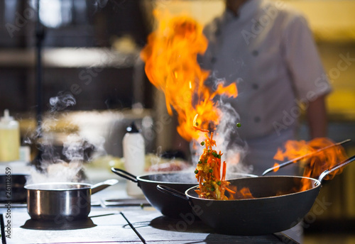 cook making dinner in the kitchen of high-end restaurant.