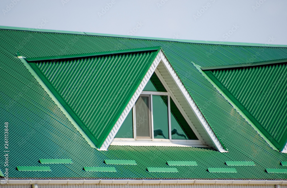 The house with plastic windows and a green roof of corrugated sheet. Green  roof of corrugated metal profile and plastic windows. Stock Photo | Adobe  Stock
