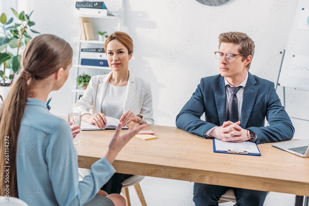 Obraz premium back view of woman speaking with recruiters during job interview