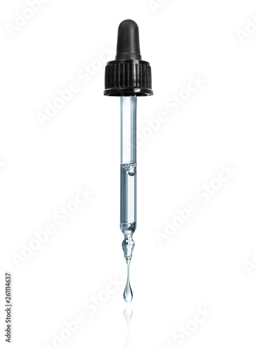 Schilderij op canvas Thick drop is dripping down from cosmetic pipette isolated on a white background