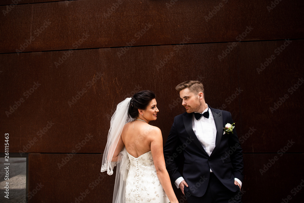 Bride and groom walking in the city, wedding day, marriage concept. Bride and groom in urban background. young couple in wedding day.
