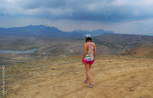 Girl looking at the mountain landscape in the desert © lierra