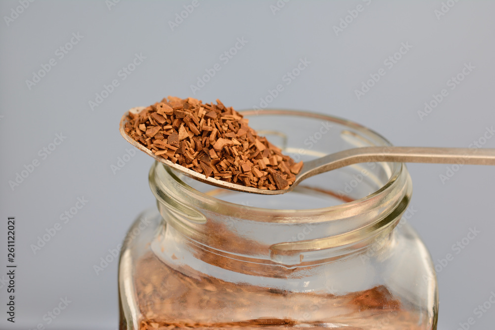 spoon with instant granulated coffee and bank filled with coffee spoon with instant granulated coffee and bank filled with coffee
