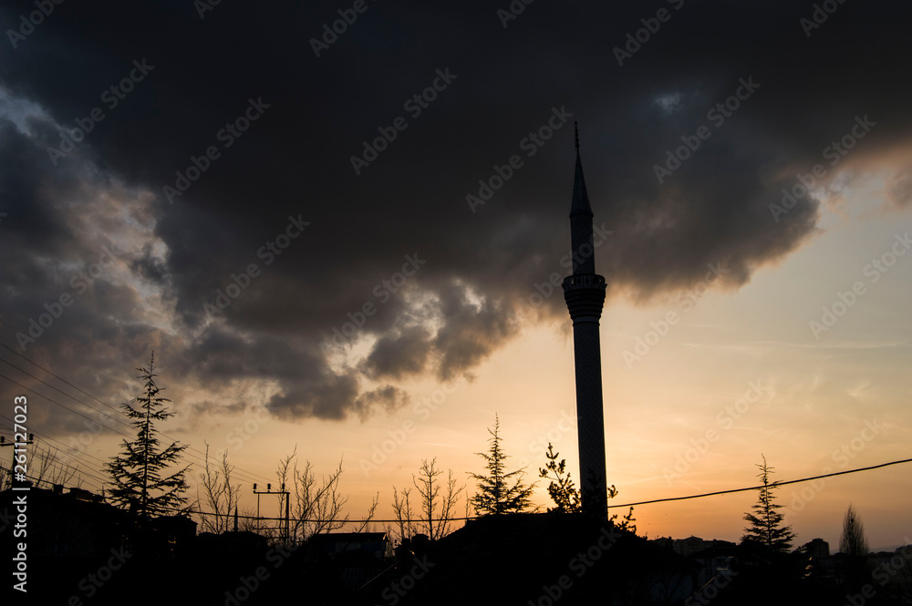 silhouette of mosque minaret at sunset,