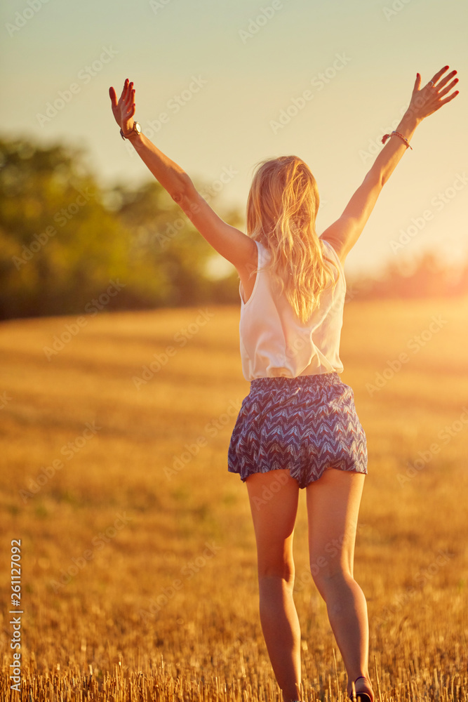 Young woman jumping and running in a wheat field. Young woman jumping and running in a wheat field.