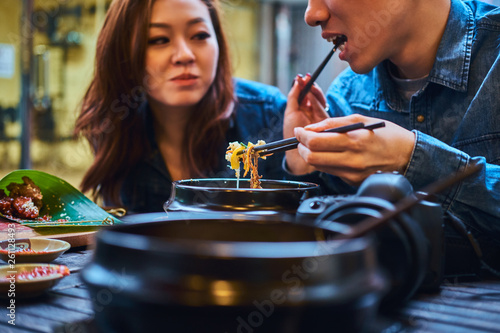 asian couple are eating at chinese cafe