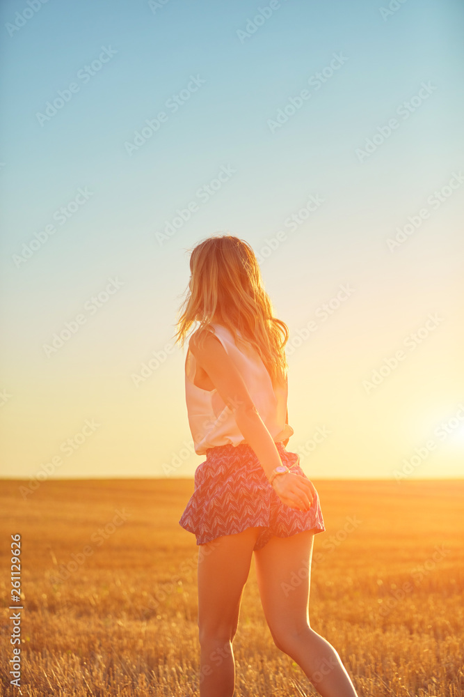 Cute young woman jumping in a wheat field. Cute young woman jumping in a wheat field.