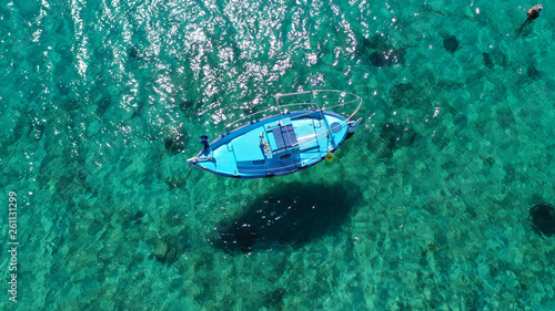 Aerial drone bird's eye view photo of traditional docked fishing boats near Naousa in island of Paros with deep emerald sea, Cyclades, Greece © aerial-drone