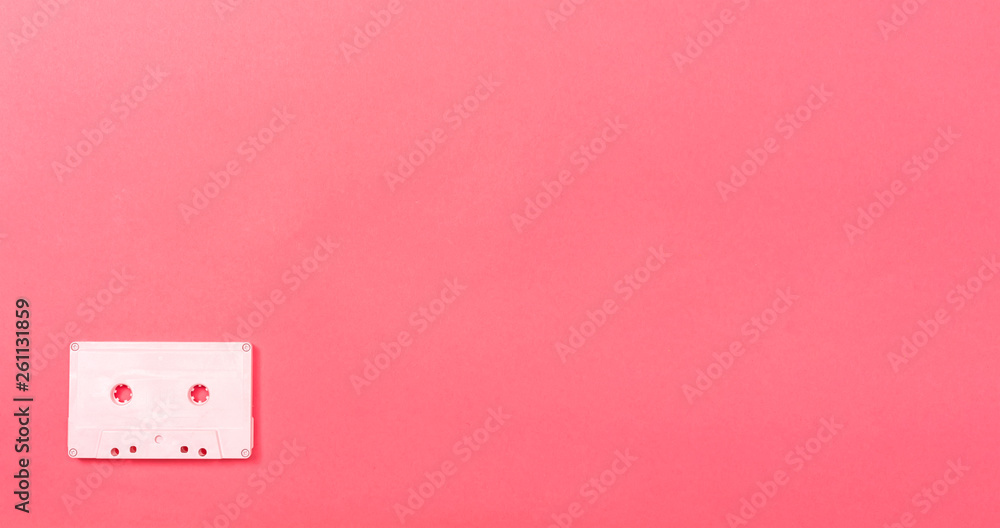 Retro cassette tape on a pink paper background Retro cassette tape on a pink paper background