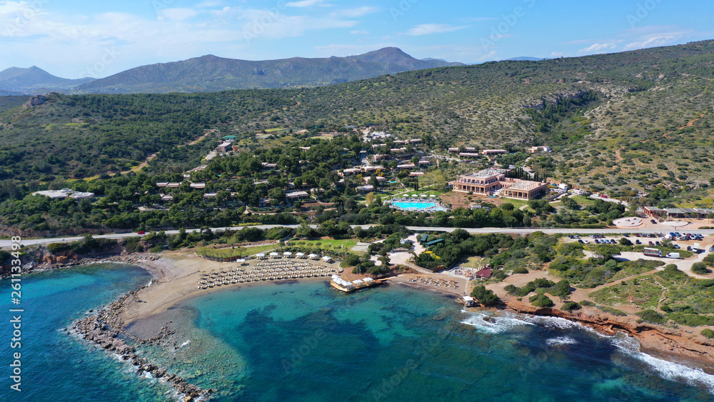 Aerial drone bird's eye view of resort near archaeological site of Cape Sounio with clear turquoise water beach, Attica, Greece