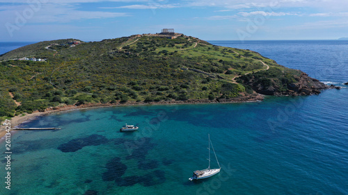 Aerial drone bird's eye view of archaeological site of Cape Sounio and magnificent Ancient temple of Poseidon on top of deep blue bay, South Attica, Greece