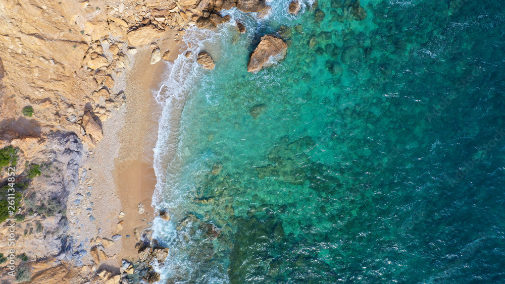 Aerial top view photo of tropical paradise deep emerald sea mediterranean sandy beach with strong waves