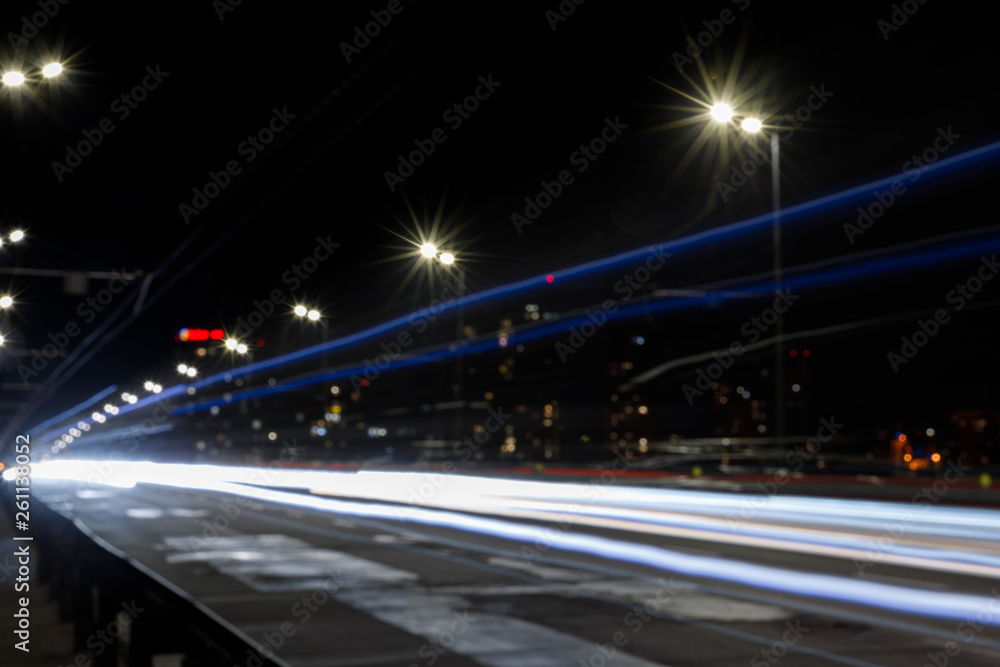long exposure of lights on road at nighttime near illuminated buildings