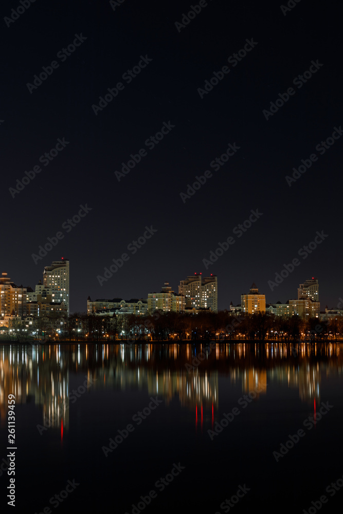 illuminated buildings with reflection on water at night
