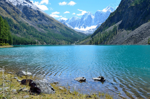  Large Shavlinskoye lake in sunny day in the background of the mountains Skazka and Krasavitsa (Tale and Beautiful) in a, Altai mountains, Russia photo