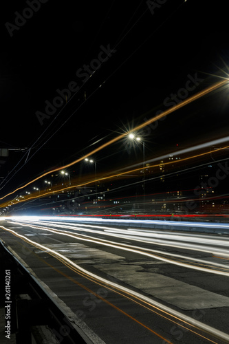long exposure of bright lights on road at night busy city