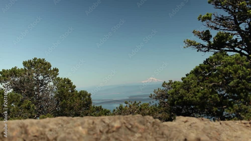Slide Along Rock Wall with Distant Mountian Peak in the Distance
