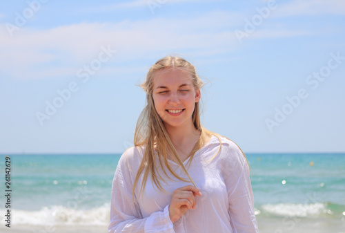 Pretty blonde woman posing on the beach © Andrej