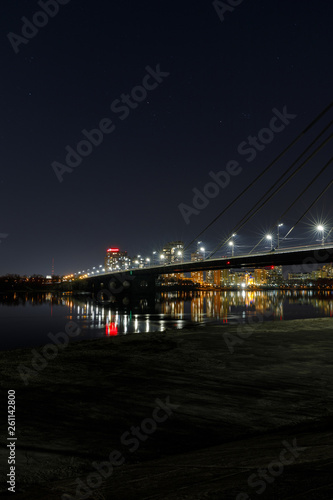 cityscape with illuminated buildings, bridge and river at nigth © LIGHTFIELD STUDIOS