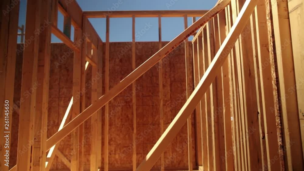 Dolly Back Through The Wooden Beams of a House Frame on a Sunny Day Dolly Back Through The Wooden Beams of a House Frame on a Sunny Day