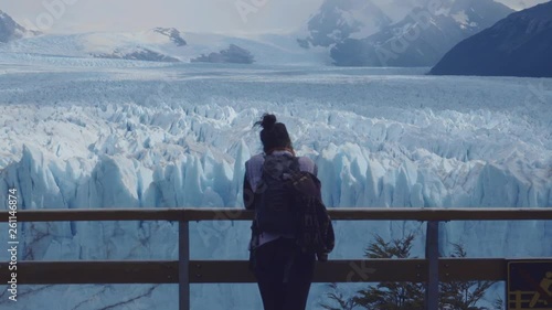 Female tourist contemplating the impressive Glaciar Perito Moreno from a terrace of the National Park Los Glaciares. 4k