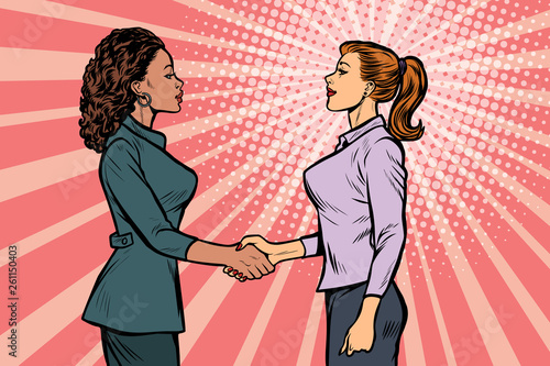 two businesswomen shaking hands