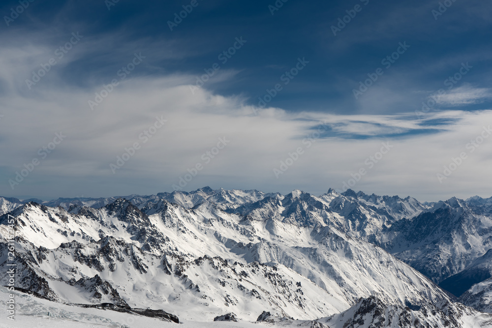 mountains in snow, blue sky, Sunny weather, white snow lying on the mountains