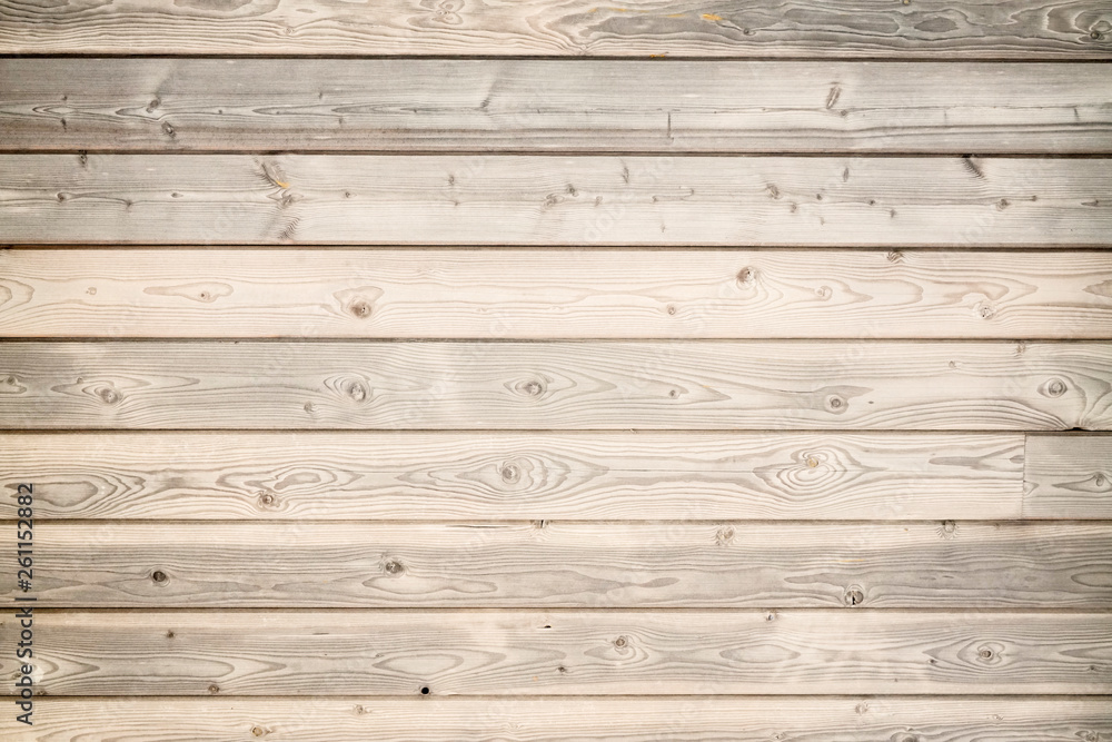 Naklejka premium Warm brown wood surface with aged boards lined up. Wooden planks on a wall or floor with grain and texture.