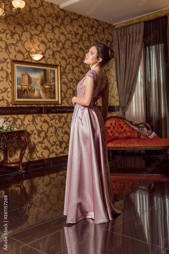 Fototapeta premium Young beautiful girl in pink luxury dress for the prom night