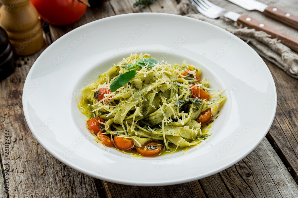 pasta with pesto sauce and tomatoes