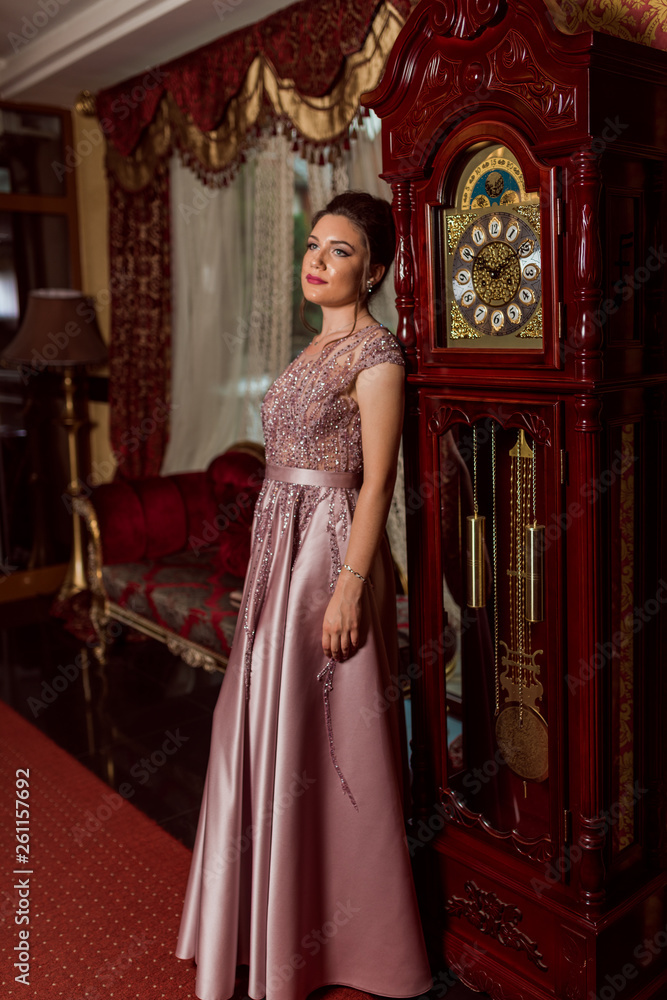 Young beautiful girl in pink luxury dress for the prom night