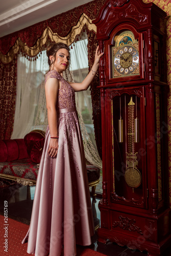 Young beautiful girl in pink luxury dress for the prom night