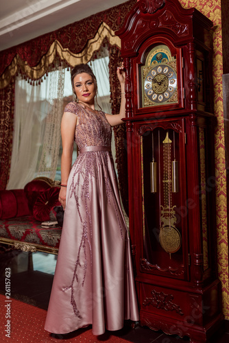 Young beautiful girl in pink luxury dress for the prom night