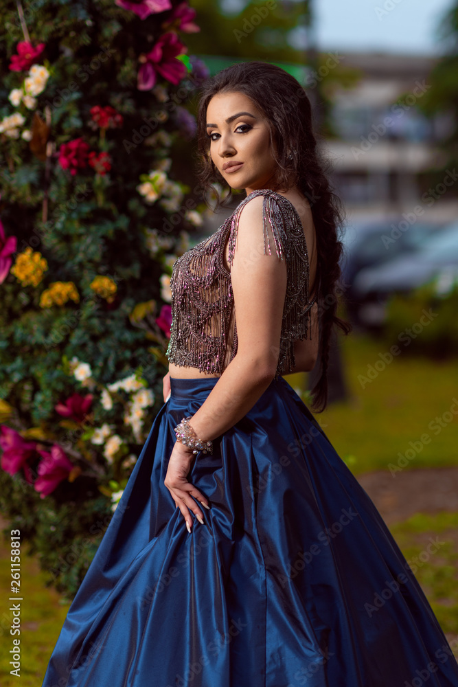 Beautiful young lady in luxury blue dress for her prom night