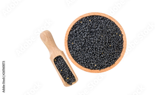 black lentils beluga in wooden bowl and scoop isolated on white background. nutrition. bio. natural food ingredient.top view.