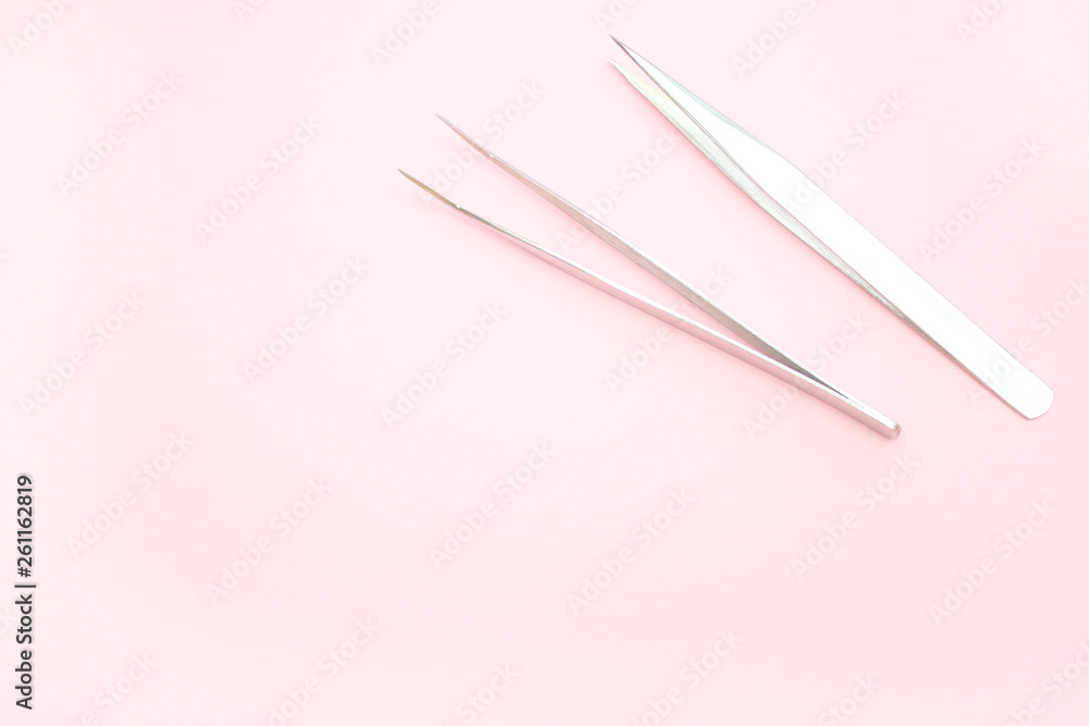 tools for Eyelash Extension Procedure. Two tweezers on pink background. copyspace mockup - Beauty and fashion concept tools for Eyelash Extension Procedure. Two tweezers on pink background. copyspace mockup - Beauty and fashion concept