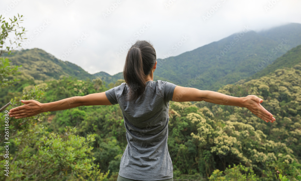 young woman feel free at forest mountain top young woman feel free at forest mountain top