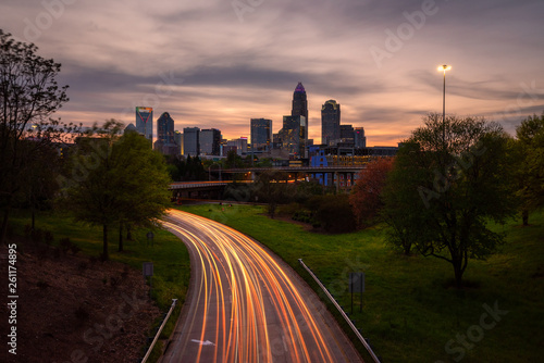 Car light trails at sunset with Charlotte city skyline in background