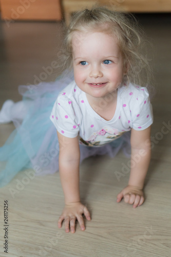 Little girl crawling on the floor and smiling