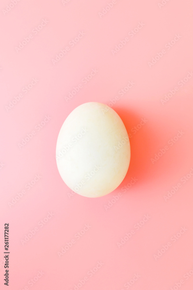 White Easter egg on yellow pastel background. Happy Easter concept. Minimal concept. Flat lay. Top view.