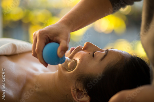 Fotografija Young Woman receiving facial rejuventation cupping  in spa wellness center