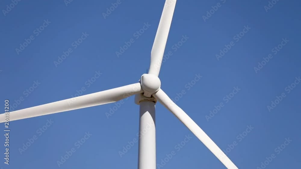 Wind turbines producing clean renewable energy. Close-up view of the blades of a wind turbine turning. Wind turbines producing clean renewable energy. Close-up view of the blades of a wind turbine turning.