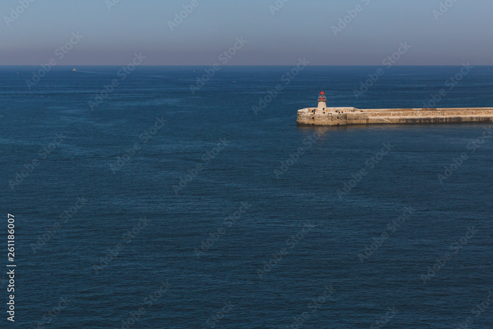 Lighthouse over water from Valletta, Malta