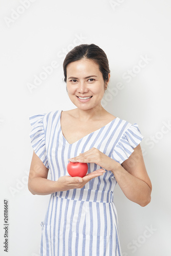 Woman holding red heart shaped